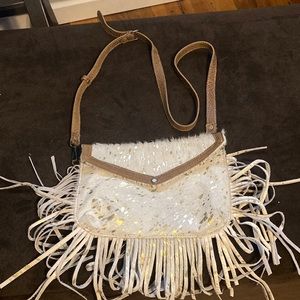 Fringe, gold and cream colored cowhide purse
